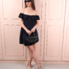 A fashionable woman wearing the Arch blue short dress, featuring a sleek silhouette and vibrant blue color, ideal for day or night events.