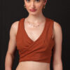 A stylish rust-brown co-ord set featuring a sleeveless wrap crop top and high-waisted pleated trousers for a bold, modern look.