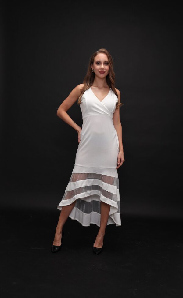 Woman wearing the Olia Midi Dress – a white sleeveless evening dress with a V-neckline and sheer striped high-low hem, ideal for elegant occasions.